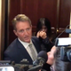 Senator Jeff Flake reacts as protesters approach him in a Capitol elevator.
